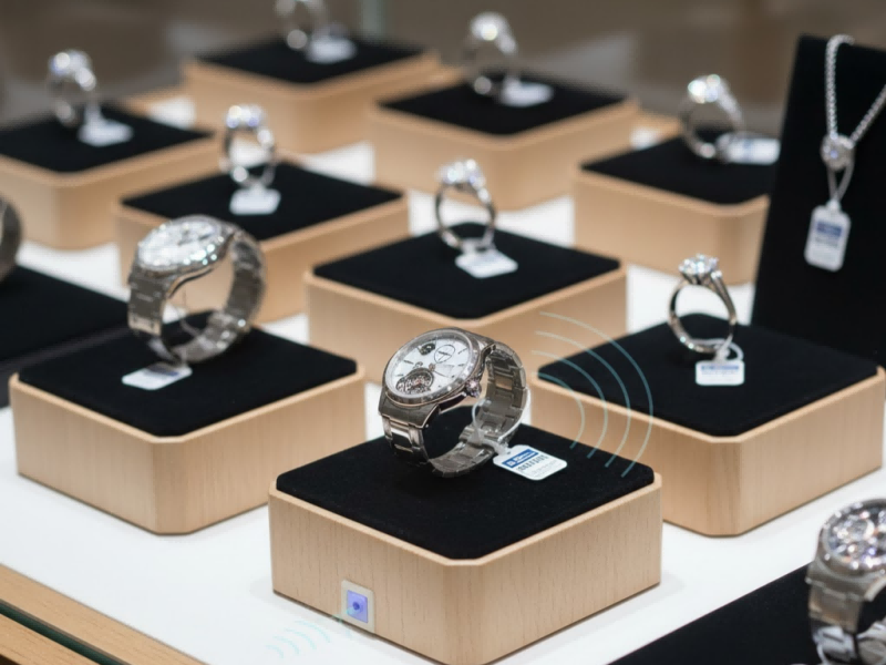 Miniaturized UHF RFID Jewelry Tags attached to high-value retail items like rings and watches for real-time inventory loss prevention Miniaturized UHF RFID Jewelry Tags attached to high-value retail items like rings and watches for real-time inventory loss prevention